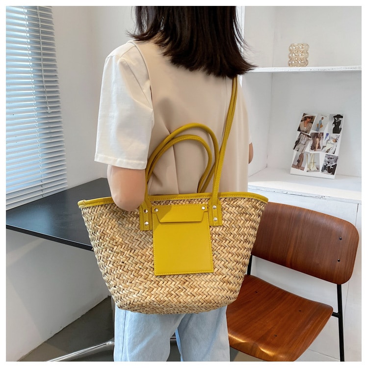 Large handmade yellow straw summer bag – worn by a model