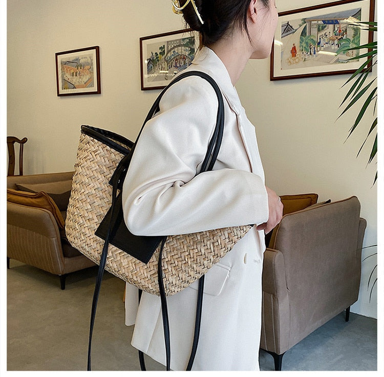 Compact rattan bag with black leather handles – worn by a model (3)