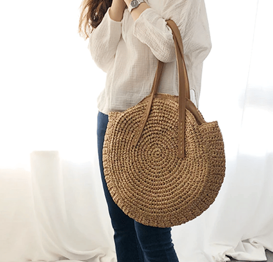 Caramel brown woven rattan beach bag – worn by a model (2)