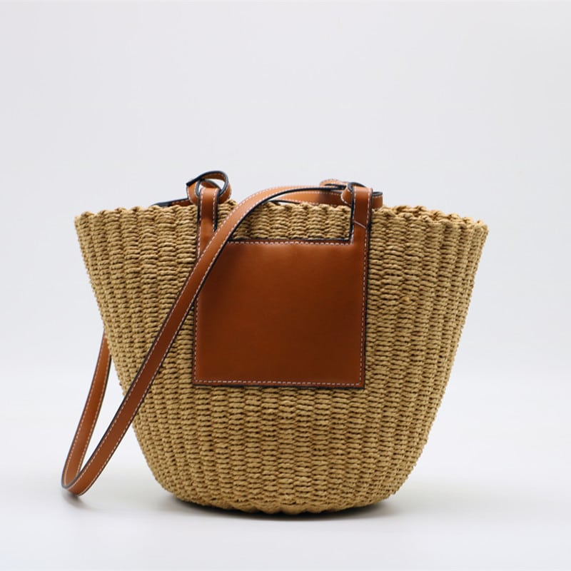 Large straw crossbody bag with a natural-tone strap