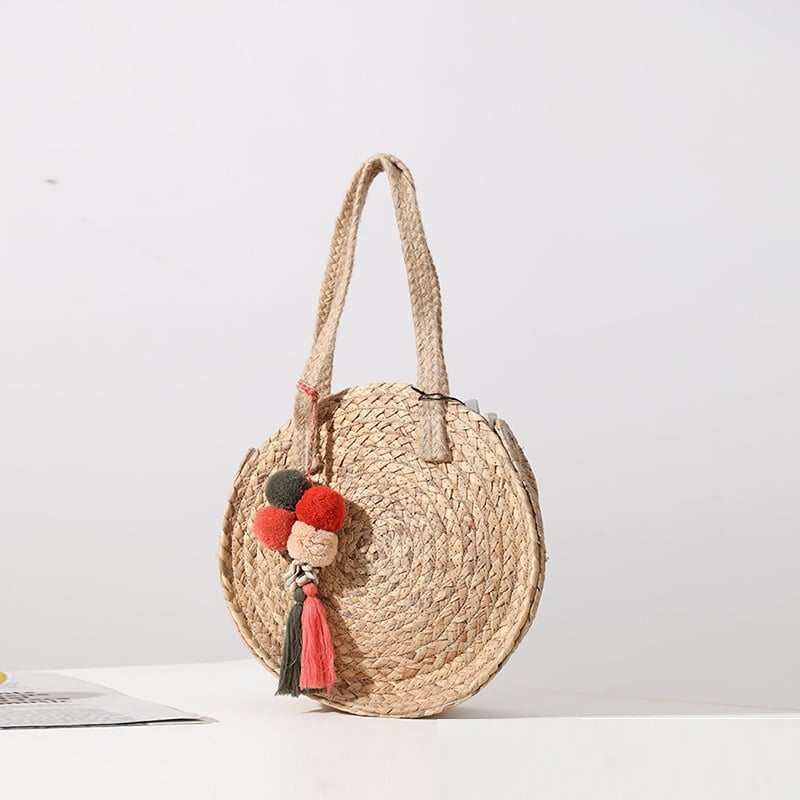 Round woven crossbody bag with a long strap