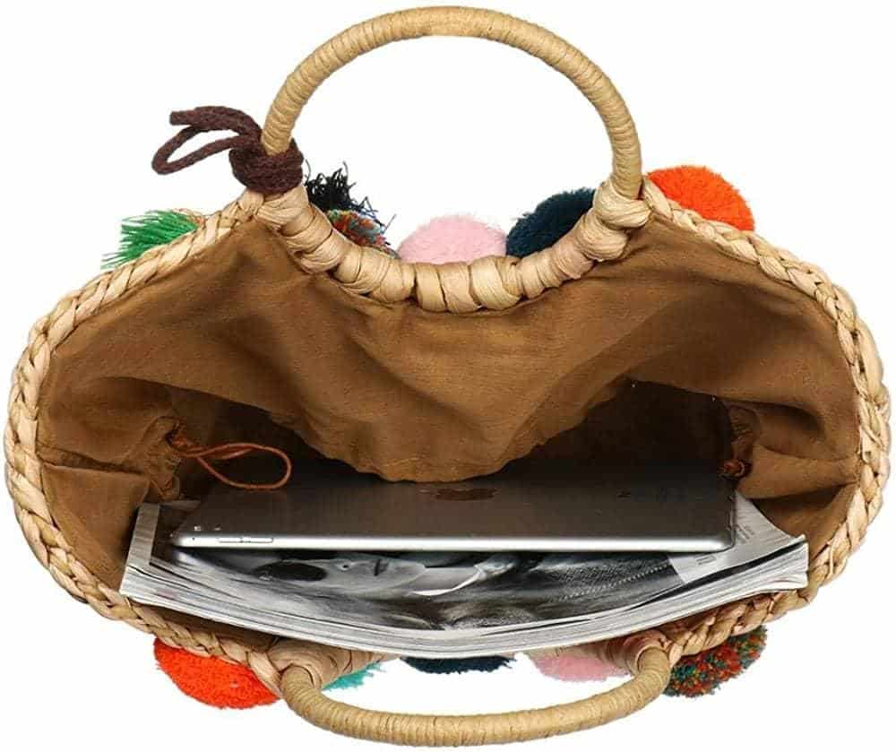 Rattan-look woven bag with multicolor pom-poms – close-up detail