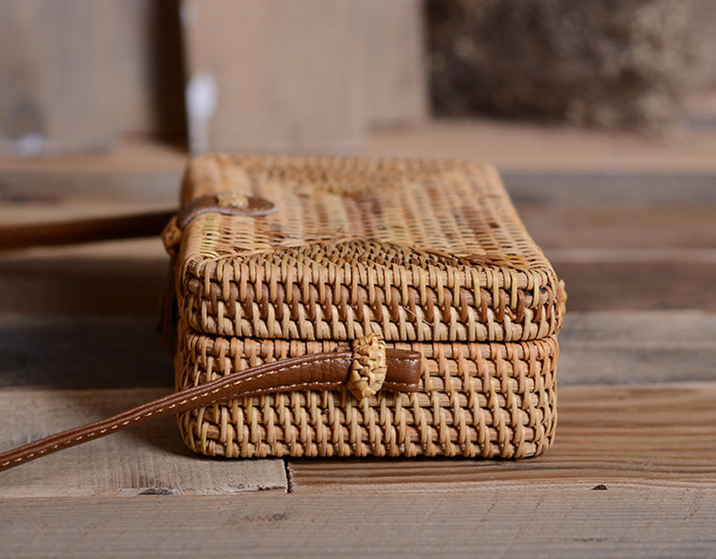 Compact rectangular hand-braided rattan bag – shown in a room setting (2)