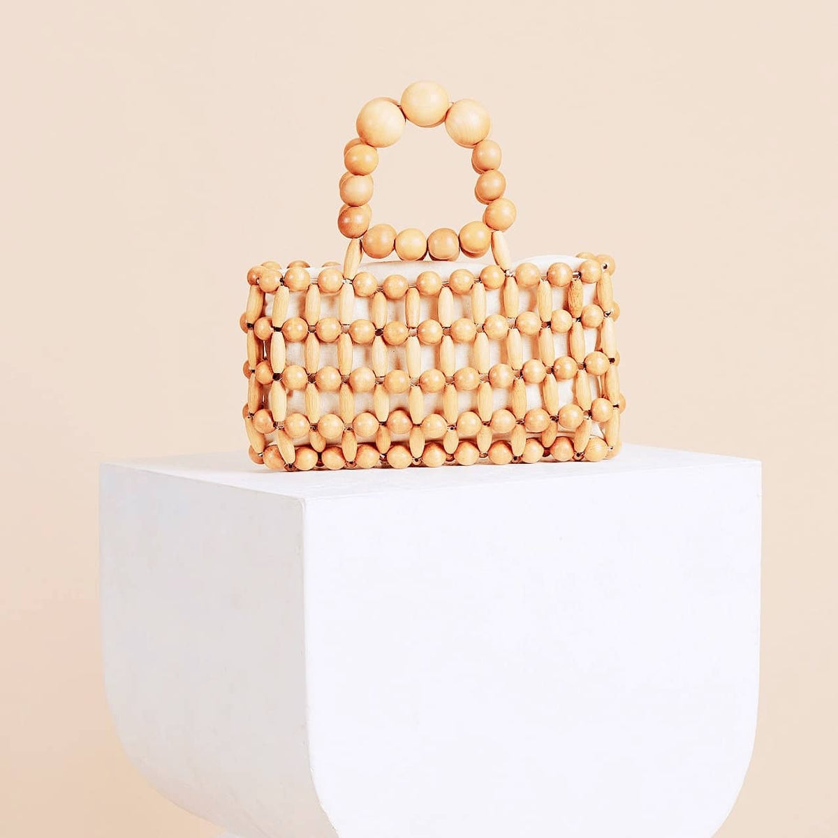 Retro woven handbag on a varnished wood frame