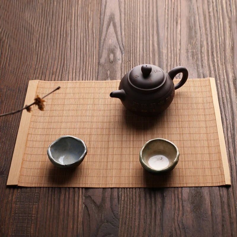 Rectangular natural bamboo placemat in a honey tone – shown in a room setting