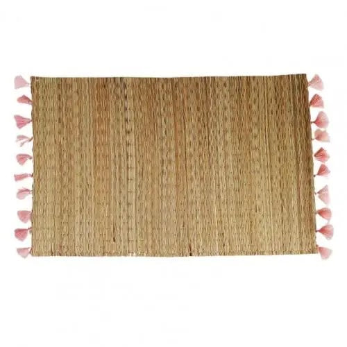 Rectangular straw placemat with pink tassels at the corners