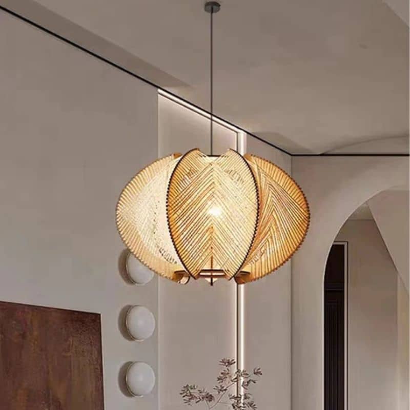 Turned wood and handwoven rattan pendant light – shown lit in a room setting