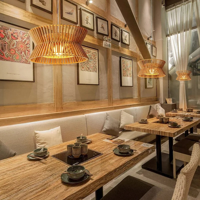 Golden-toned curved wood pendant light – shown in a room setting (2)