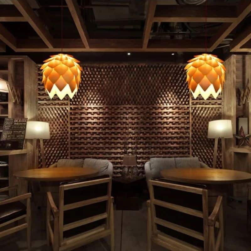 Pine cone woven wood pendant light – shown lit in a room setting