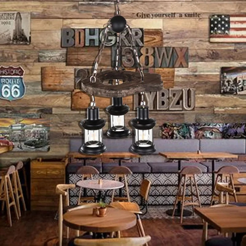Driftwood branch chandelier with exposed filament bulbs – shown in a room setting