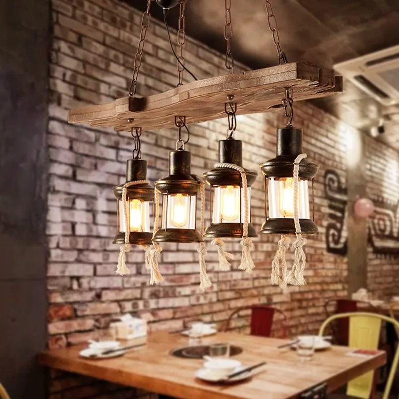 Industrial driftwood pendant with geometric LED lanterns – shown lit in a room setting