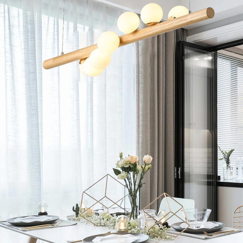 Wood and blown glass globe LED pendant light – shown in a room setting
