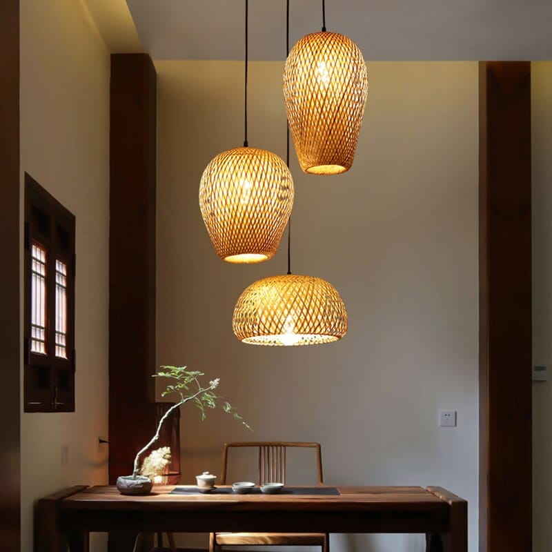 Three-shade handwoven rattan pendant light – shown lit in a room setting
