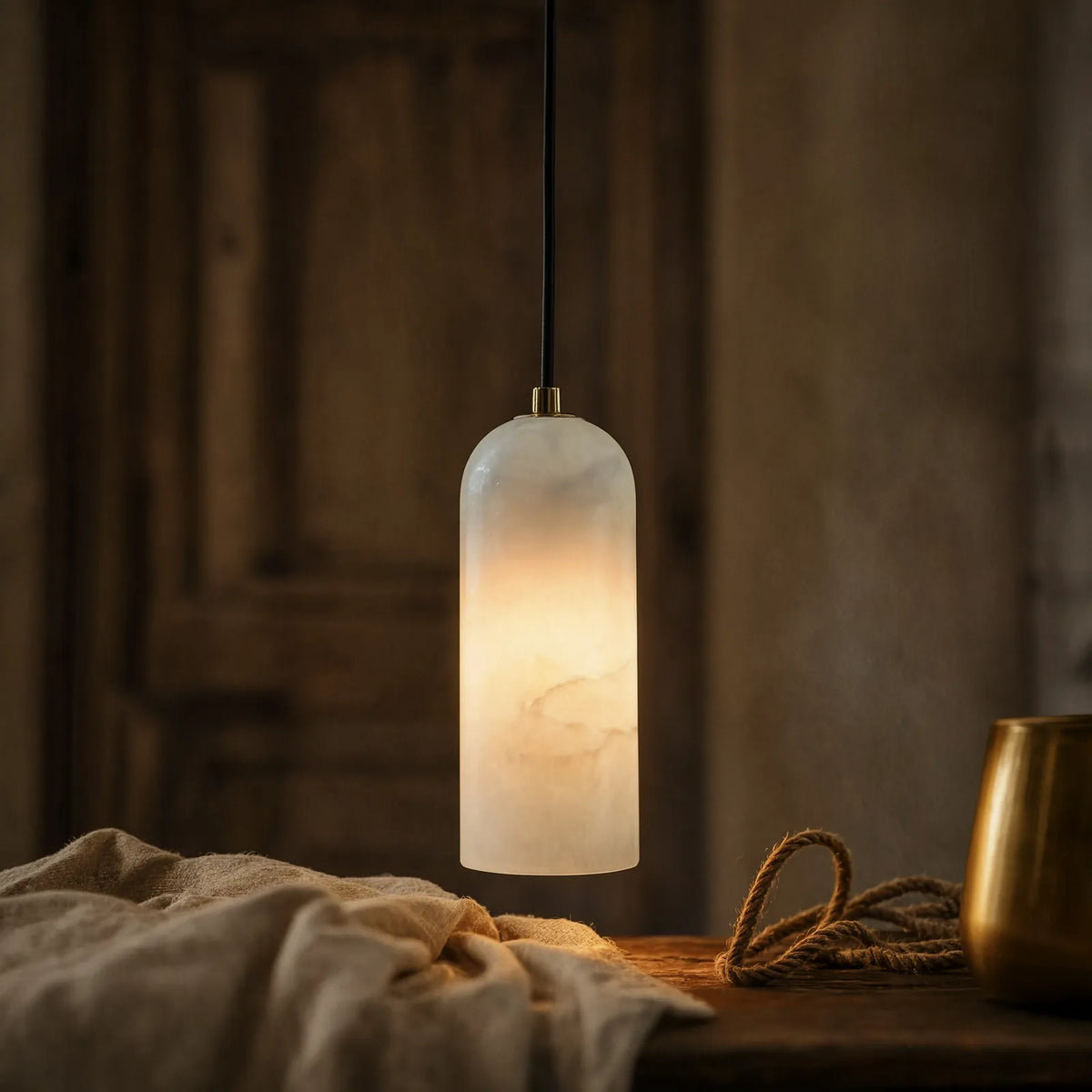 Tarente translucent marble pendant light with brushed brass canopy – shown in a room setting (2)