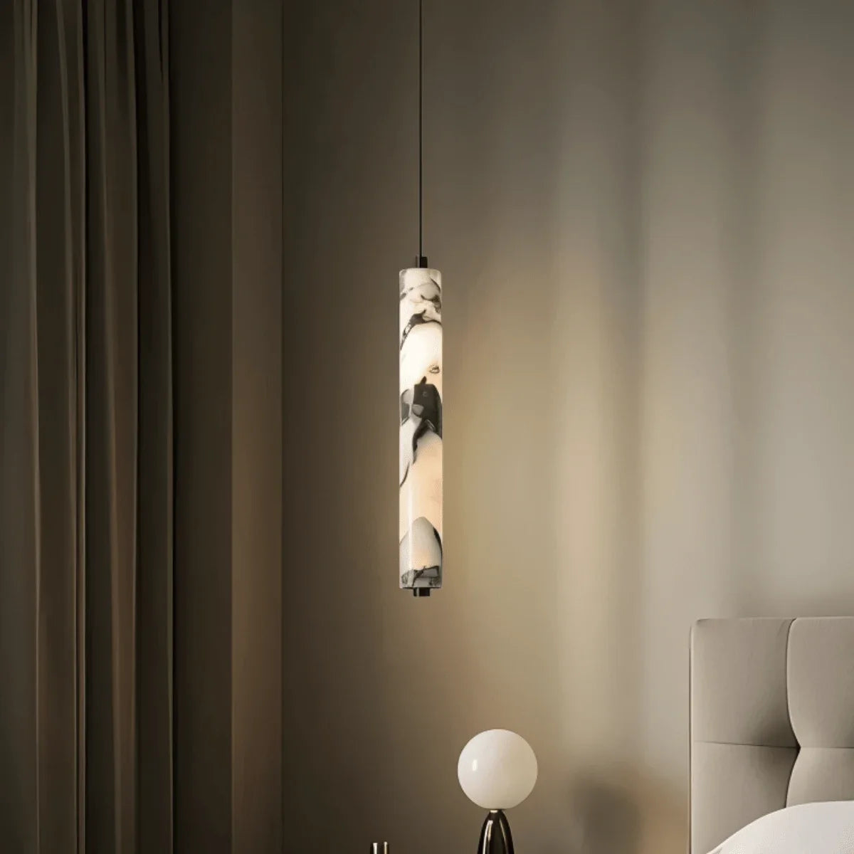Sélinonte slim marble tube pendant light – shown in a bedroom