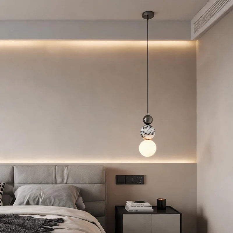 Locres marble and opal glass globe pendant light – shown in a bedroom