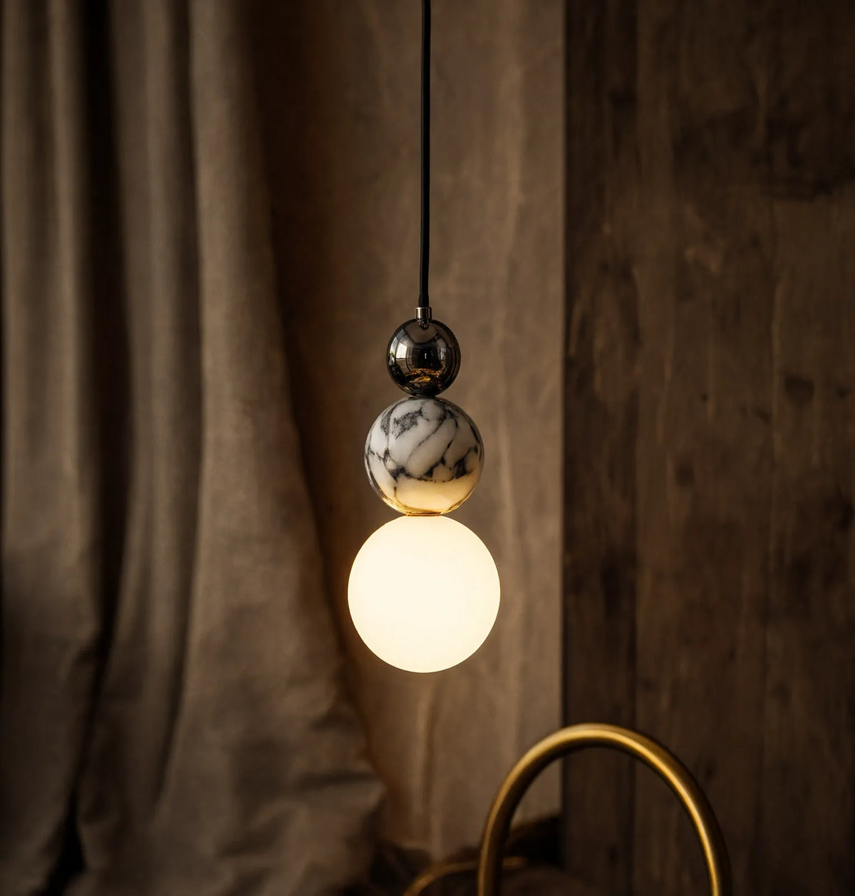 Locres marble and opal glass globe pendant light – shown in a room setting (3)
