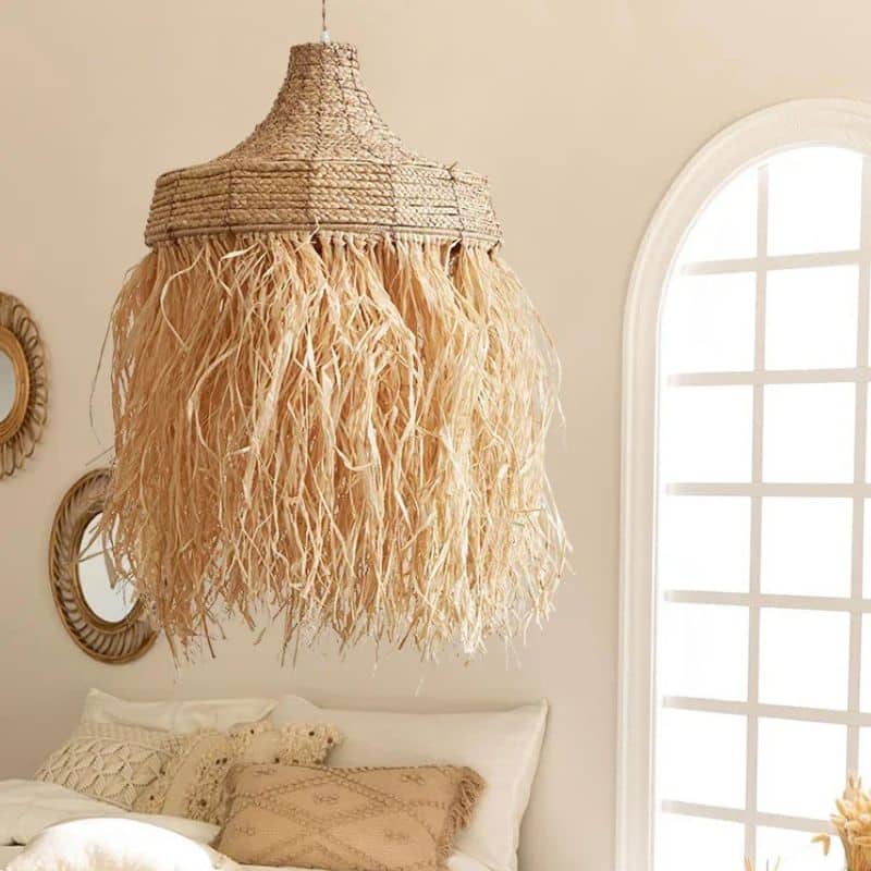 Handwoven textured straw pendant light with a rounded silhouette – shown in a room setting