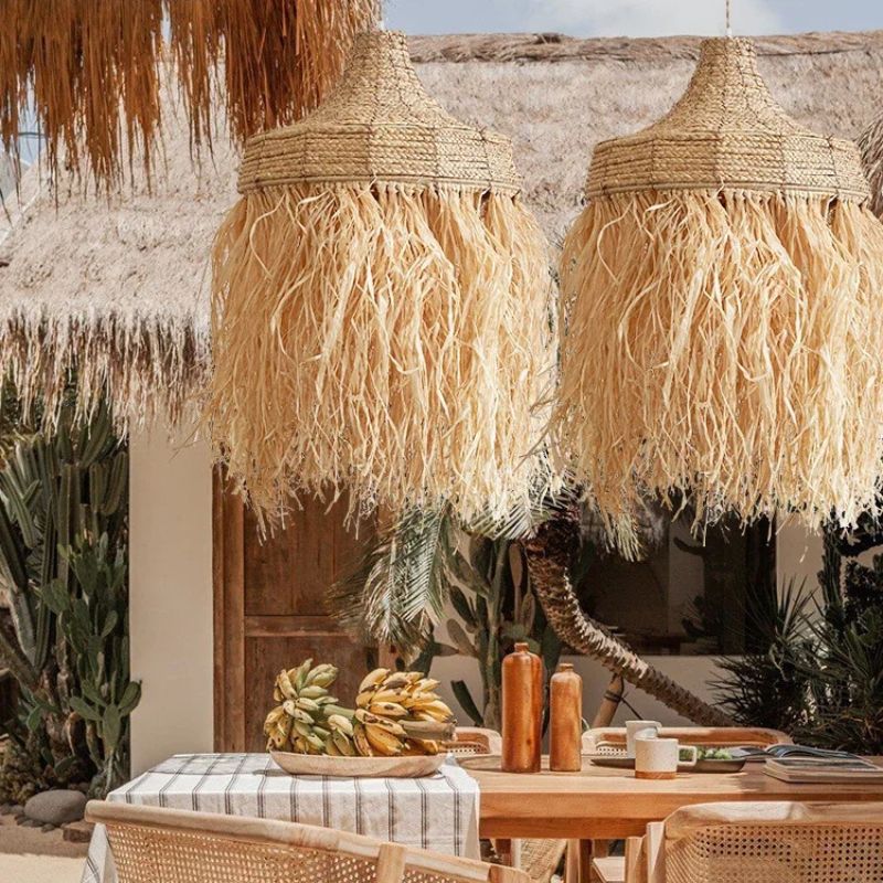 Handwoven textured straw pendant light with a rounded silhouette – shown in a room setting (2)