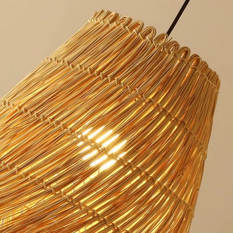 Modern straw pendant light with woven arches radiating around the diffuser – close-up detail, lit