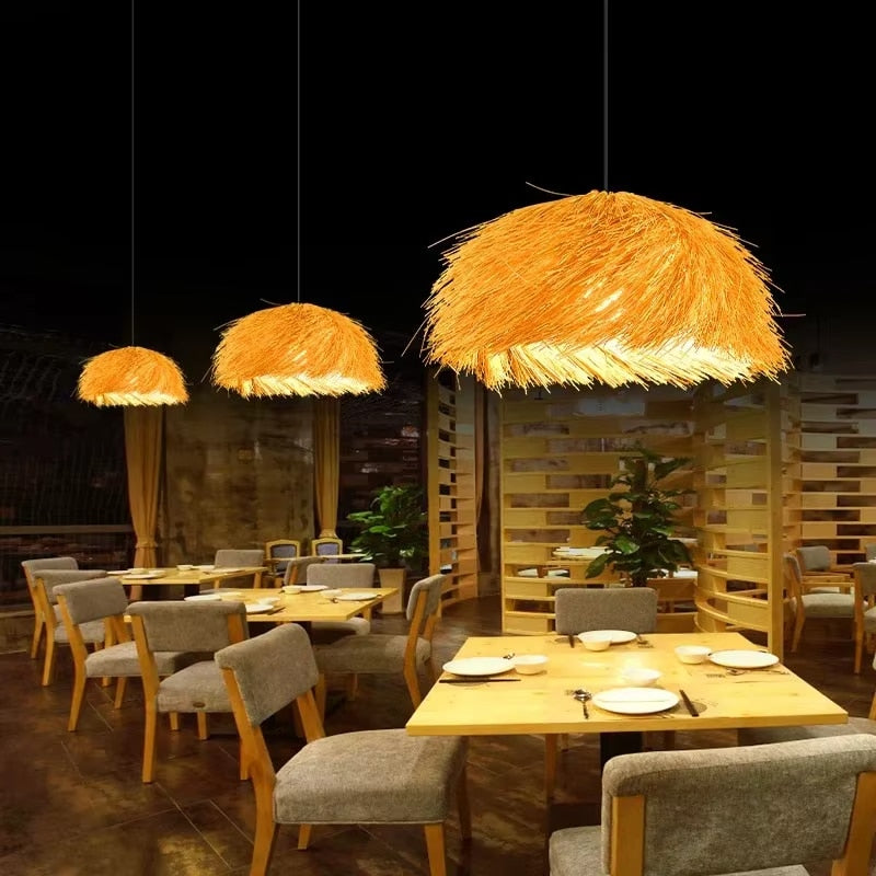 Round braided straw pendant light with a natural matte texture – shown lit in a room setting