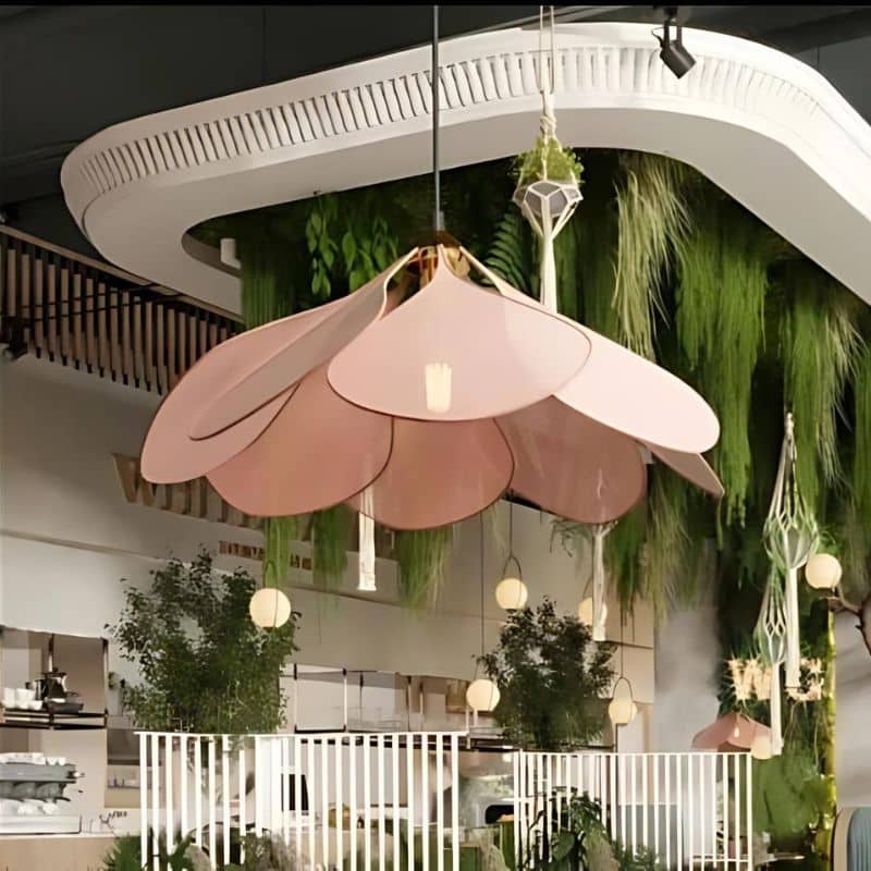 Rattan-look fabric petal pendant light with wide flared petals – pink variant, shown in a room setting