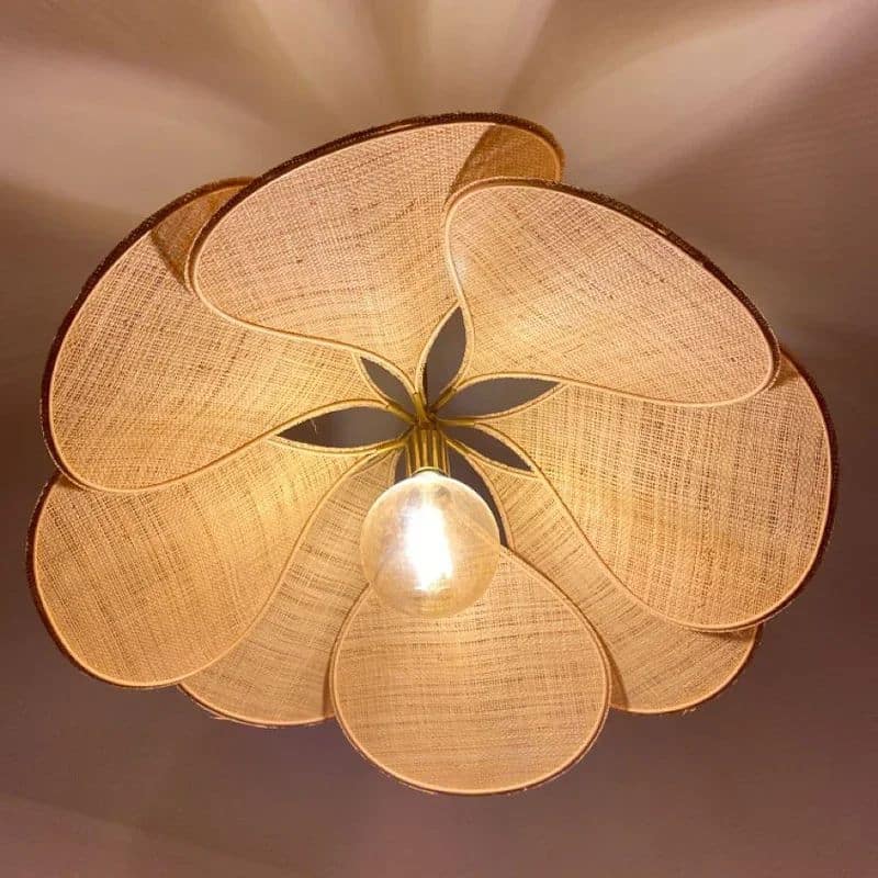 Rattan-look fabric petal pendant light with wide flared petals – close-up detail, lit