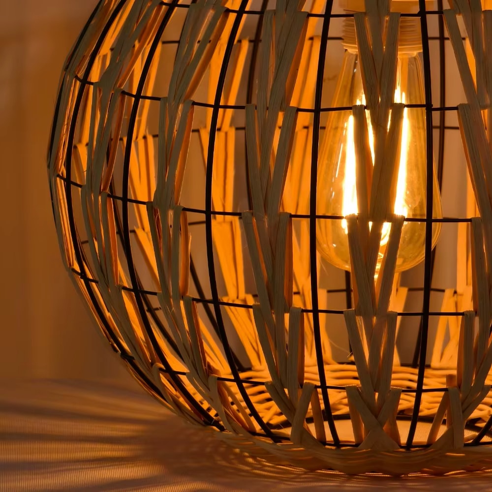 Rustic two-tone beige and black rattan cage pendant light – close-up detail, lit