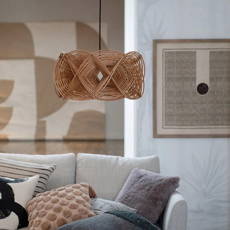 Sculptural handwoven openwork rattan pendant light – shown in a room setting