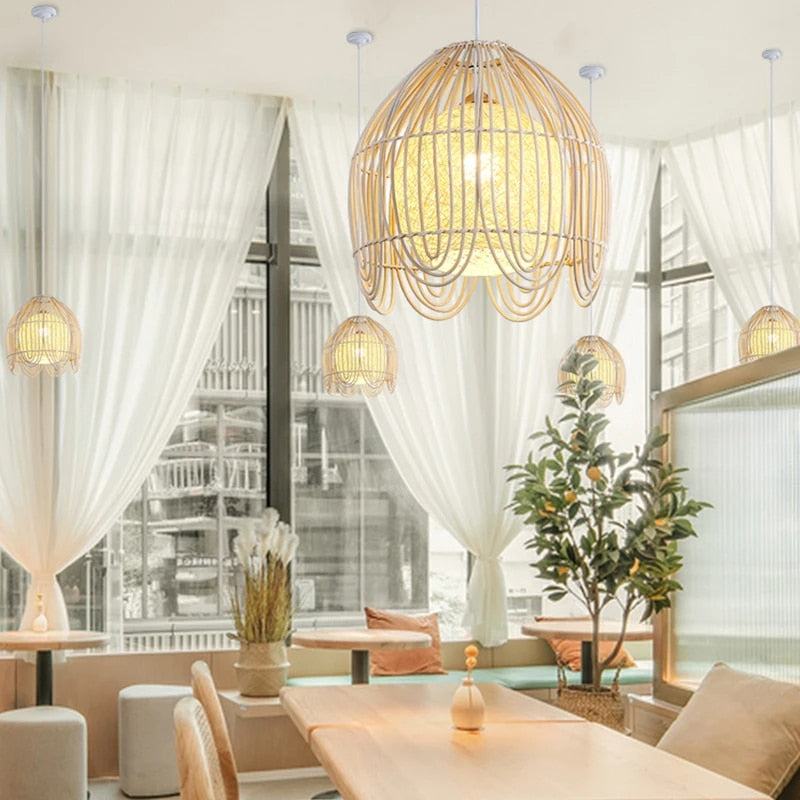 Geometric handwoven rattan, bamboo and wicker pendant light – shown lit in a room setting (2)