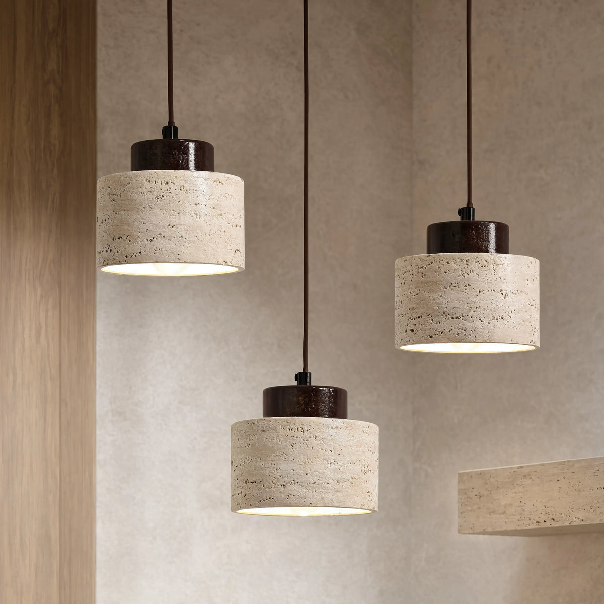 Velia travertine drum pendant light with dark wood cap – shown in a room setting