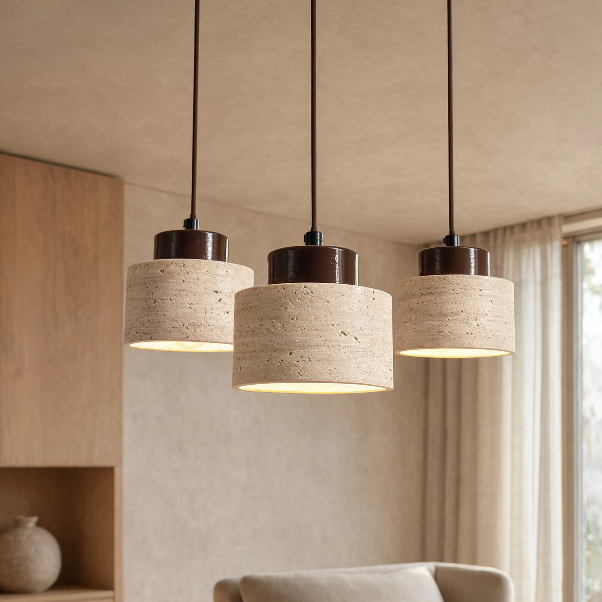 Velia travertine drum pendant light with dark wood cap – shown in a living room (2)