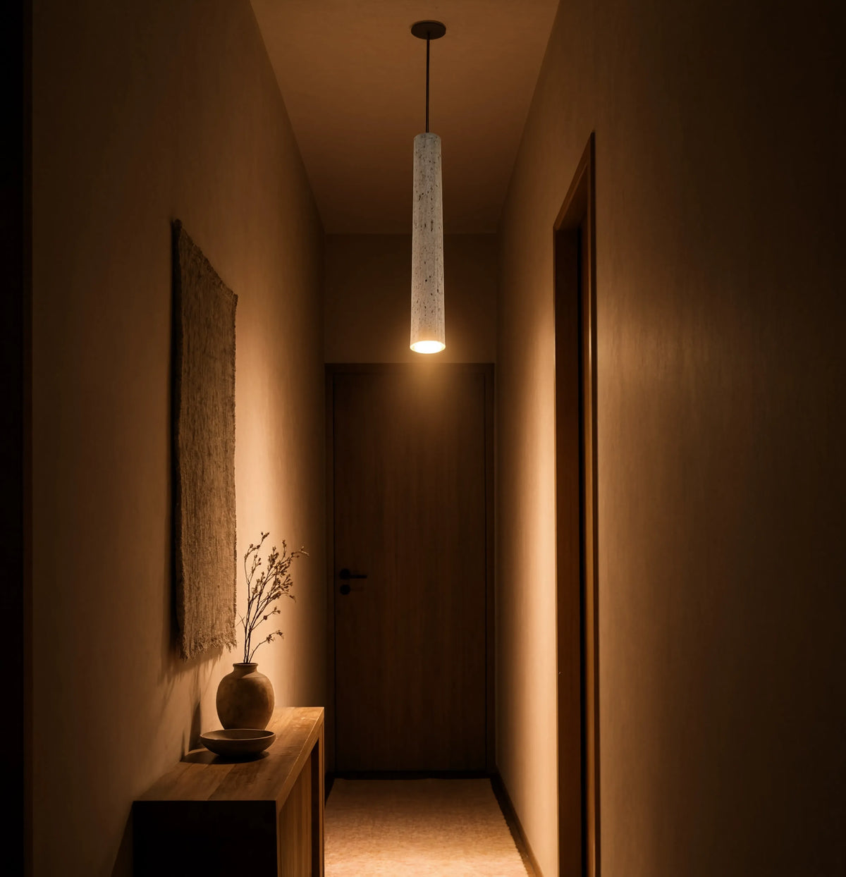Cumes long travertine tube pendant light – shown in an entryway