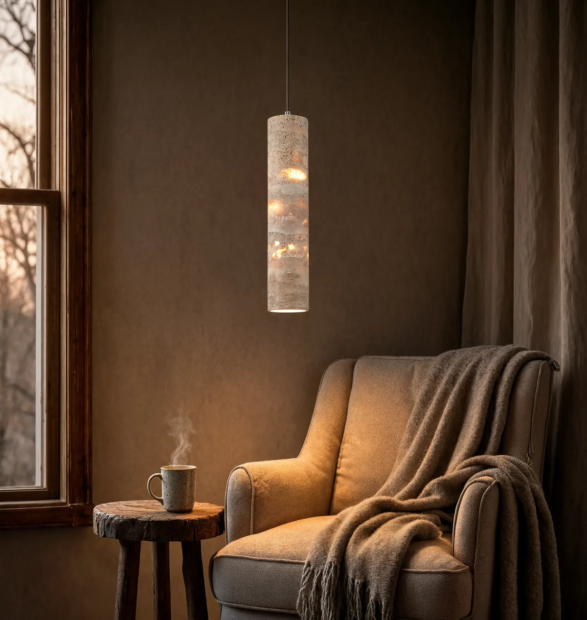 Camarina slim travertine tube pendant light – shown lit in a room setting (2)