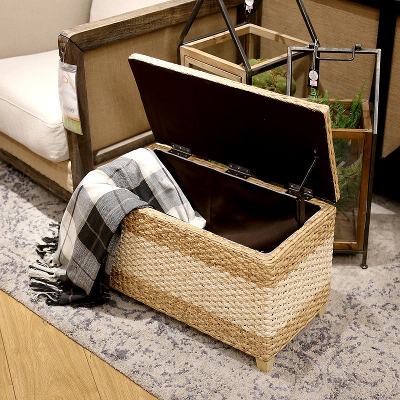 Rectangular hand-braided rattan storage stool with a removable lid – shown in a room setting (4)