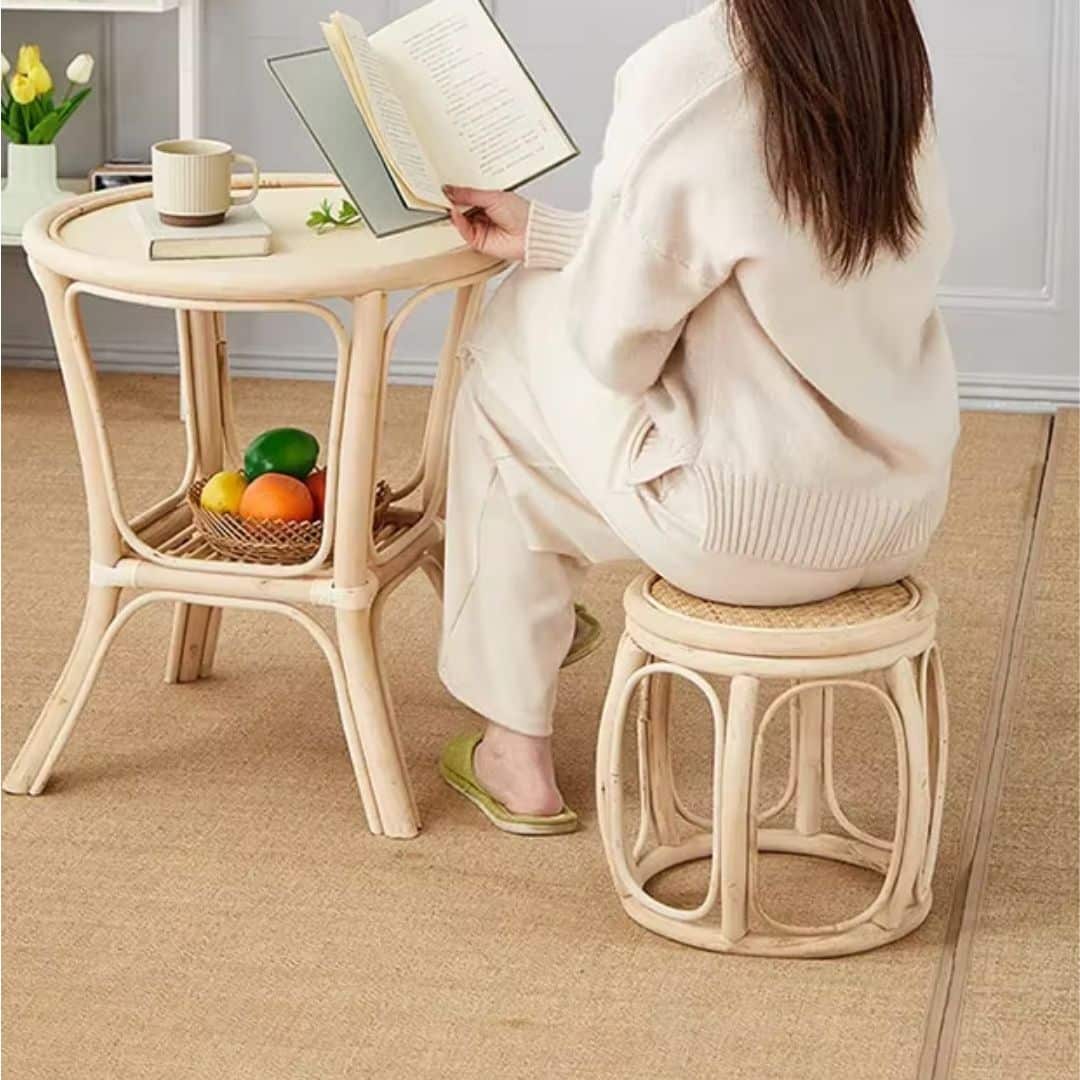 Retro low round wicker stool with a hand-braided seat – shown in use