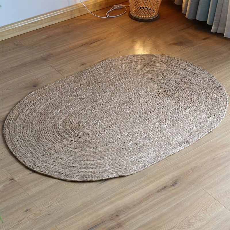 Oval handwoven genuine wicker rug in warm beige – shown in a room setting