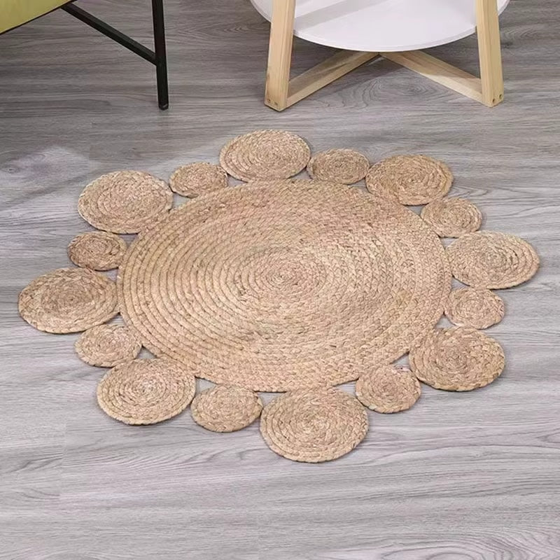 Round handwoven golden beige wicker rug – shown in a room setting (2)