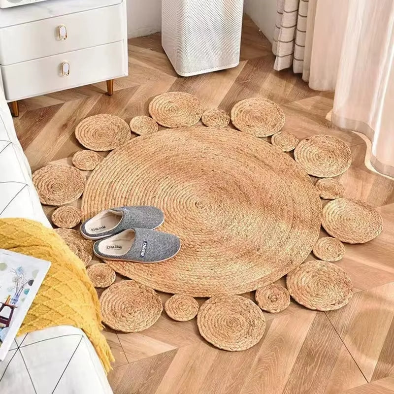 Round handwoven golden beige wicker rug – shown in a room setting