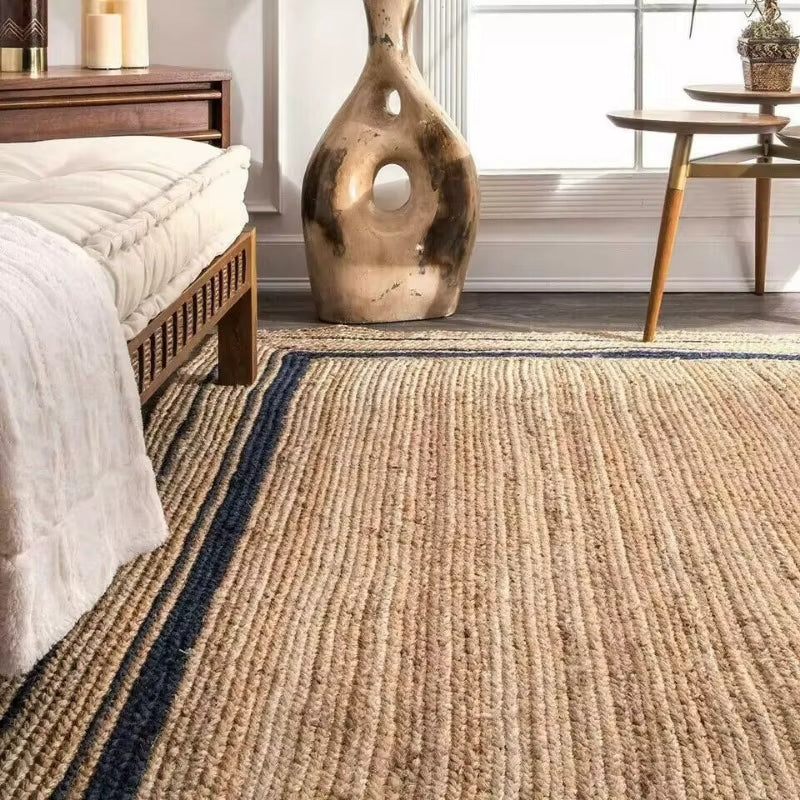 Rustic rectangular wicker rug with dark edging – shown in a room setting
