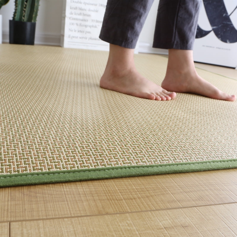 Rectangular synthetic rattan rug with a green border – shown in use (2)