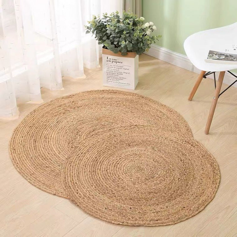 Round light honey rattan rug with a relief texture – shown in a room setting