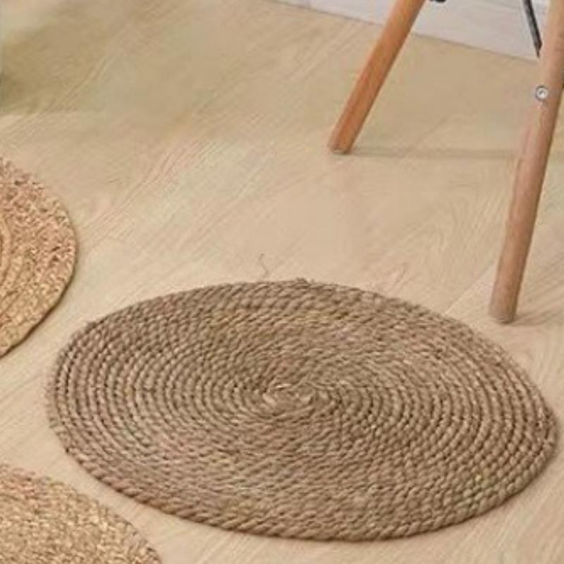 Round dark brown rattan rug – shown in a room setting (2)