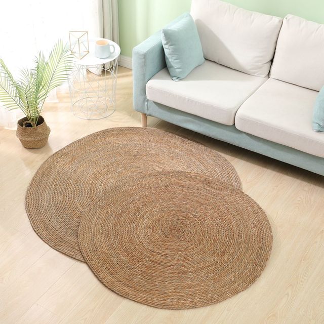 Round dark brown rattan rug – shown in a room setting