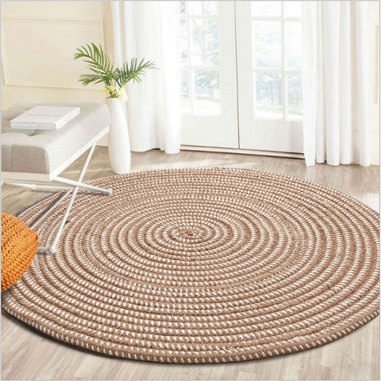 Round white and brown synthetic rattan rug – shown in a room setting