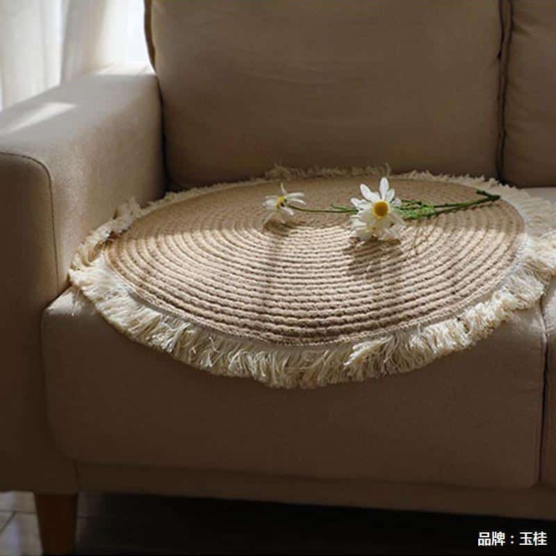 Round handmade cotton and linen rug with a pom-pom fringe – shown in a room setting (3)