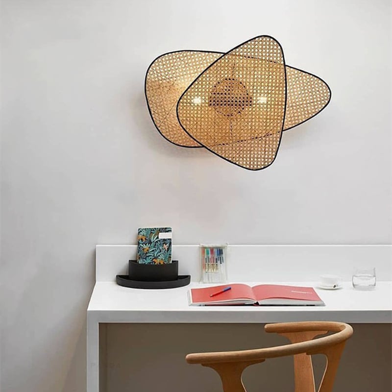 Retro rounded handwoven rattan wall light – shown in a room setting