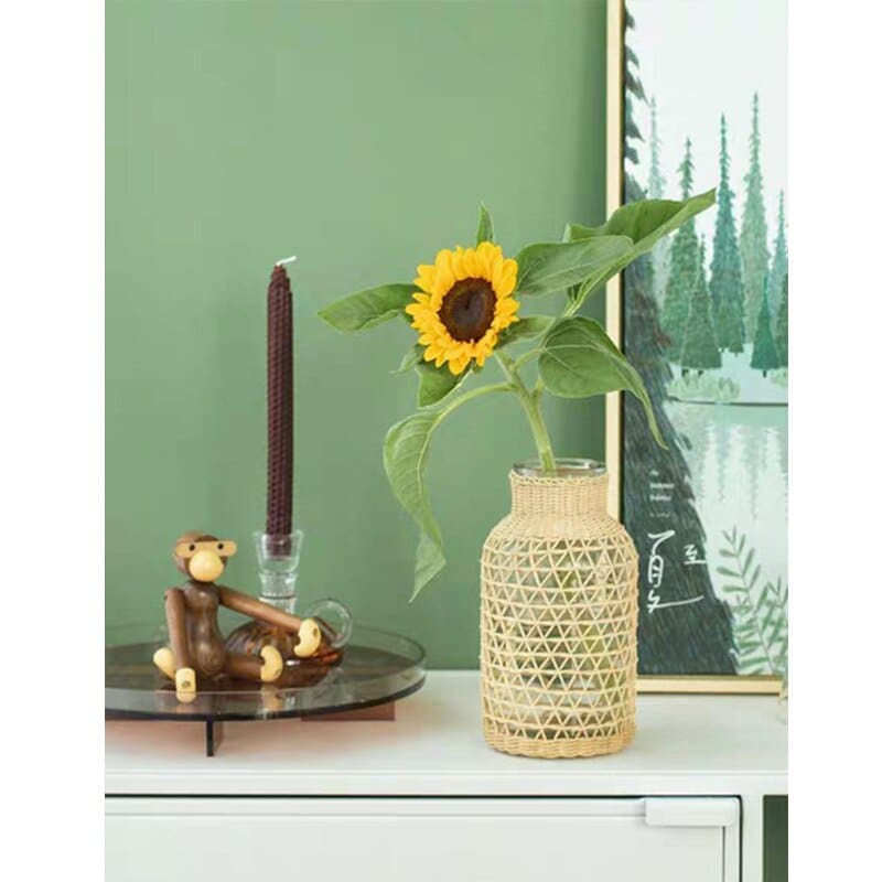 Blown glass vase with a handwoven triangle-pattern sleeve – shown in a room setting