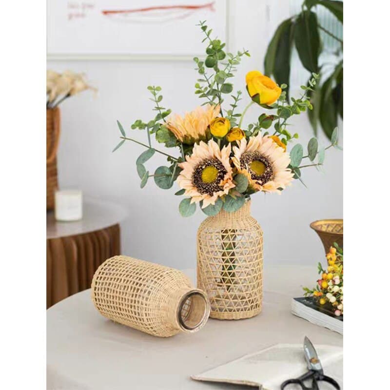 Clear glass vase wrapped in a woven square-pattern sleeve
