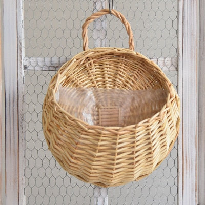 Round hanging rattan wall vase with golden highlights – yellow variant, shown in a room setting